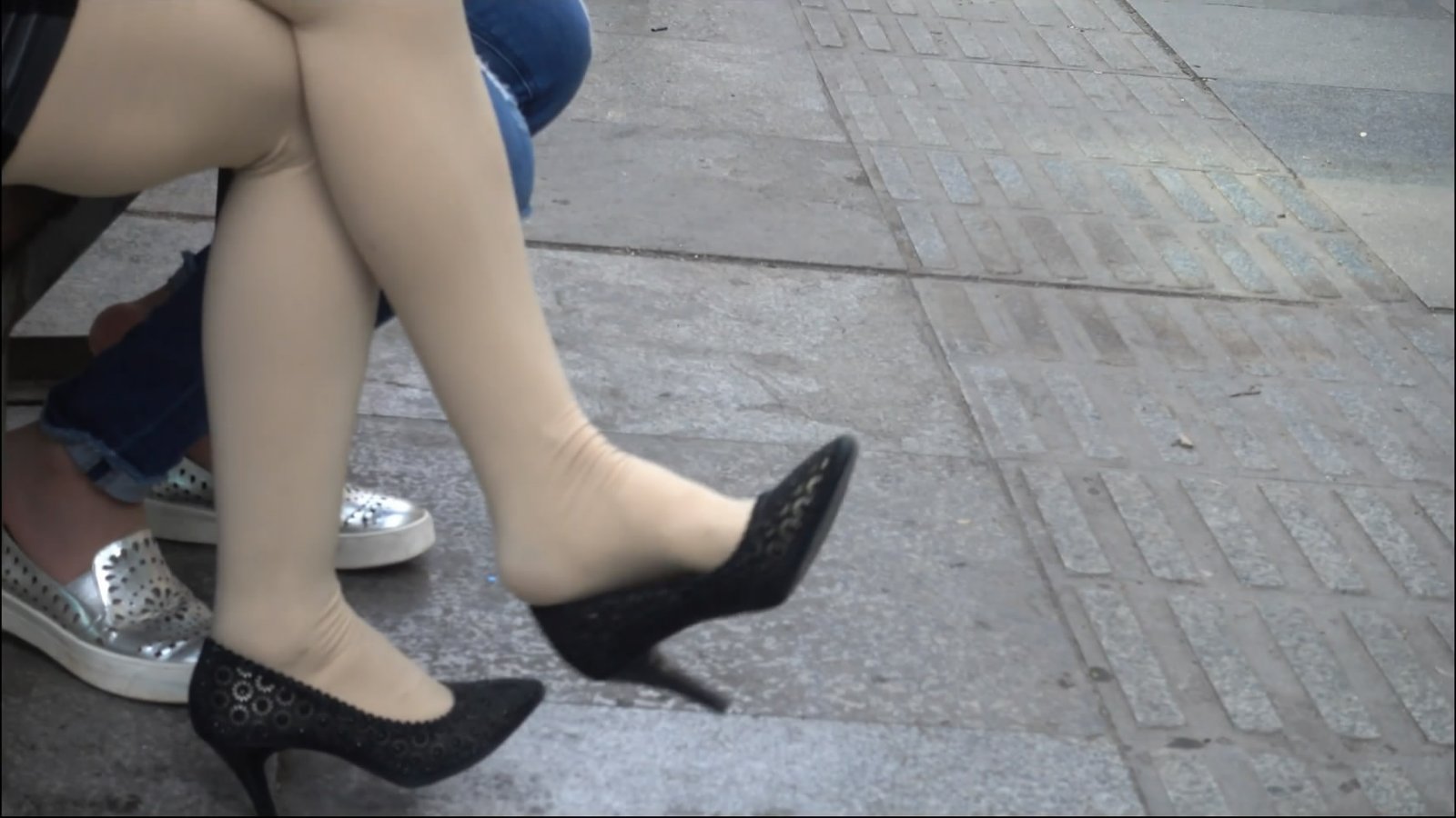 Two dangling women waiting for someone